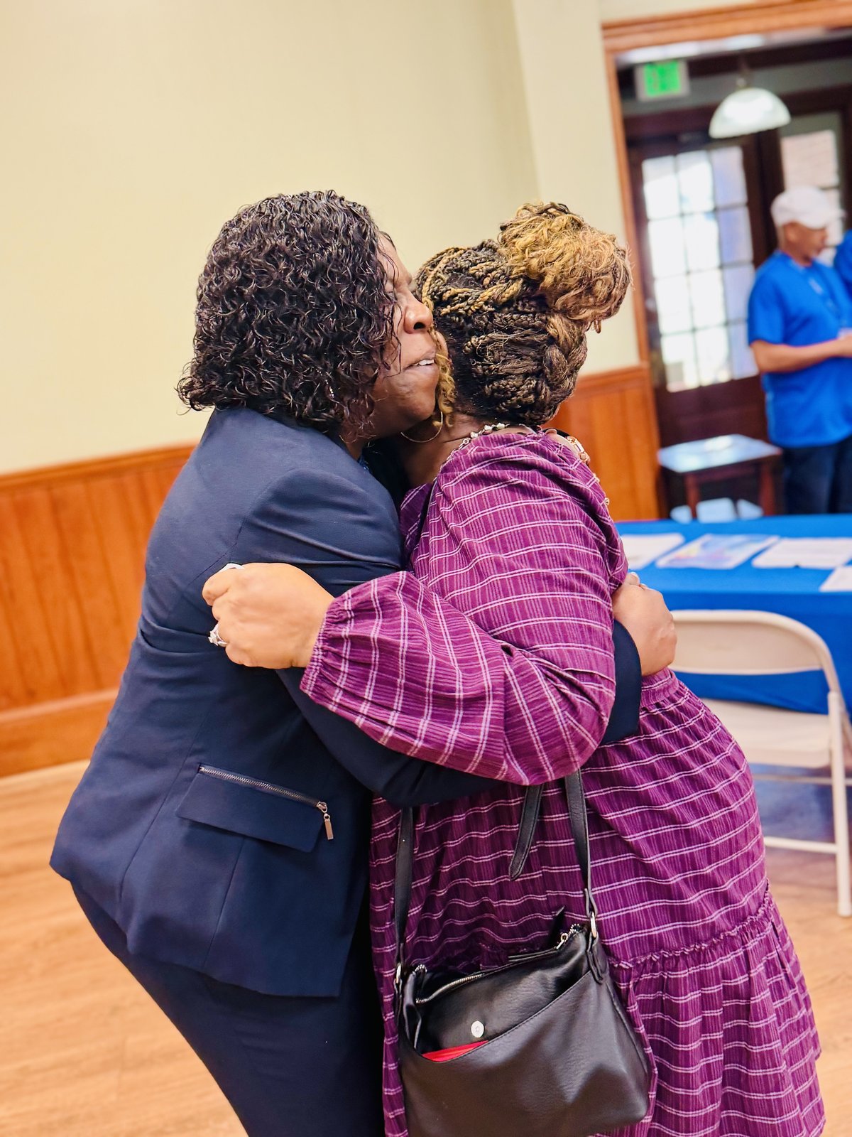 Cynthia Johnson embracing a community member