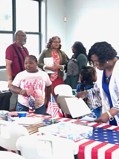 Community members at a red, white and blue campaign event